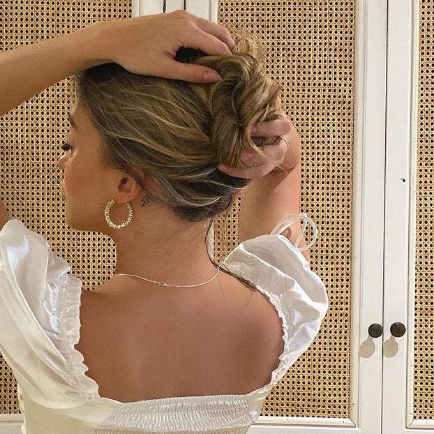 Woman in white dress wearing amazing gold hoop earrings from Drae Collection